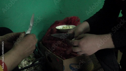 Woman peeling garlic preparation for cooking in the kitchen.