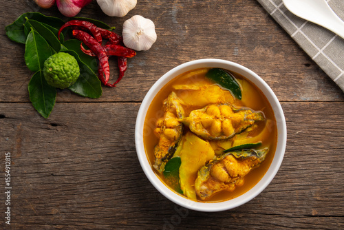 Southern style sour and spicy soup,Yellow Thai Curry Sour Bamboo Shoot with catfish in a bowl.Top view.