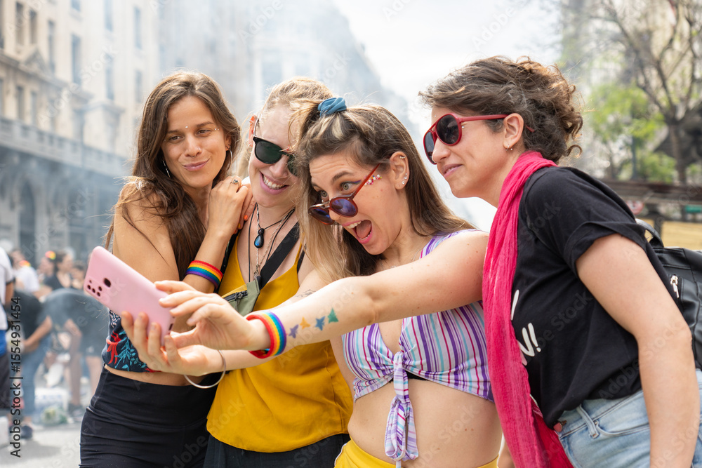 Obraz premium Four young women taking a selfie at gay pride parade