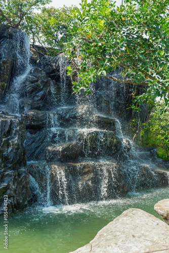 Garden Waterfalls in slow shutter,summer some small waterfall at a Japanese Garden,rest in park,mountain river stream waterfall green forest,nature plant tree rainforest.