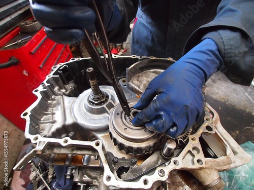 A mechanic is servicing an automatic transmission
