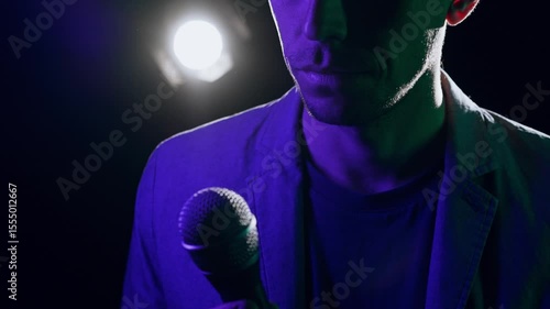 Speaker Making Cross Gesture with Microphone Before Pivotal Lecture