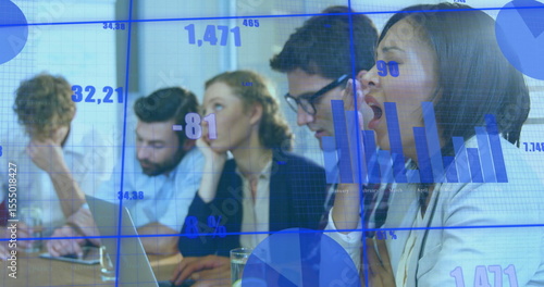 Foto Yawning female colleague wearing light blazer at conference table, with laptop p