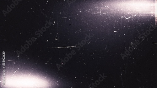 White light leaks with a textured black background and grunge effect for overlay designs and vintage effects