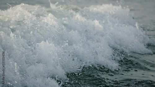 Foamy lake water with wake Horizontal