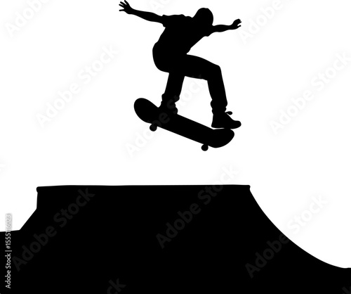 silhouette of a skateboarder jumping