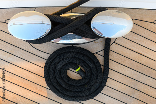 Mooring line coiled on deck on superyacht. Mooring gear on yacht. Superyacht equipment. 