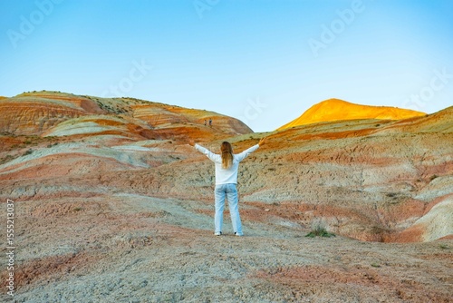 Girl walking in the mountains of Khizi at sunset