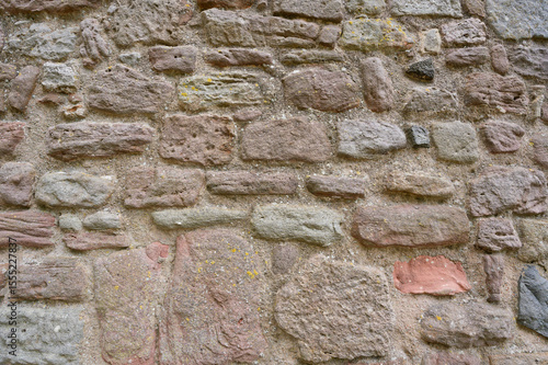 Old stone wall texture, rough masonry background of natural rocks in ancient architecture