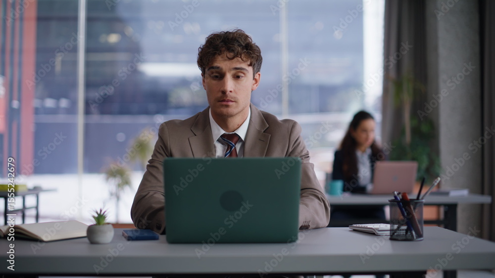 Focused executive thinking solution at coworking. Businessman working laptop Focused executive thinking solution at coworking. Businessman working laptop