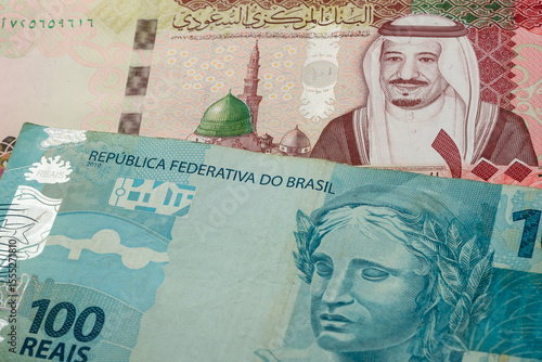 Wallpaper Mural 100 Saudi riyal and 100 Brazilian real banknotes. International trade concept Torontodigital.ca