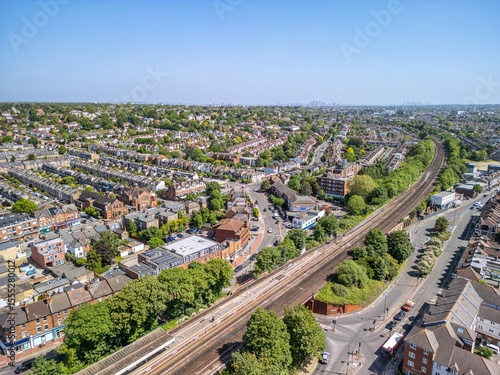 The drone aerial view of Raynes Park. Raynes Park is a residential suburb, railway station and local centre near Wimbledon, London, and is within the London Borough of Merton.