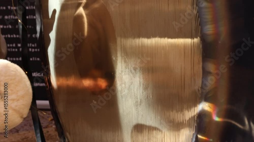 A mallet strikes the Paiste gong