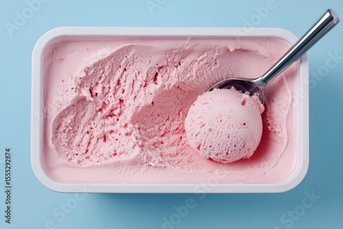 strawberry ice cream scooped out of container