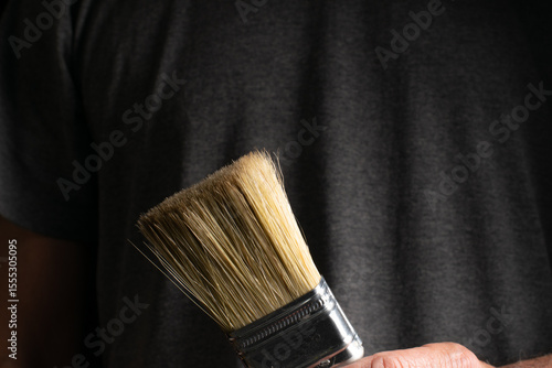 Close-up of natural bristle paintbrush against dark background