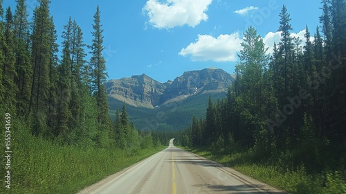 Scenic Highway Journey through Majestic Canadian Rockies Under Azure Skies