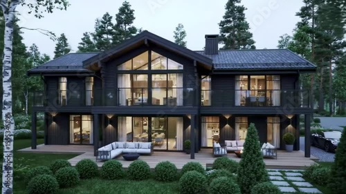 View of a modern dark gray two story house with large windows and a wooden deck surrounded by trees