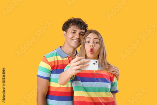 Young couple in rainbow shi...