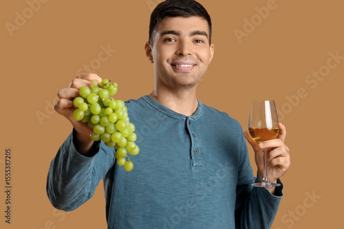 Smiling young man holding f...