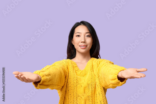 Young Asian woman opening a...