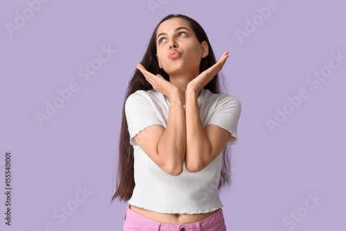 Happy young woman blowing k...