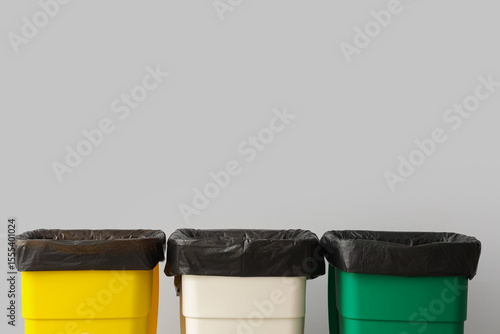 Empty trash bins near grey ...