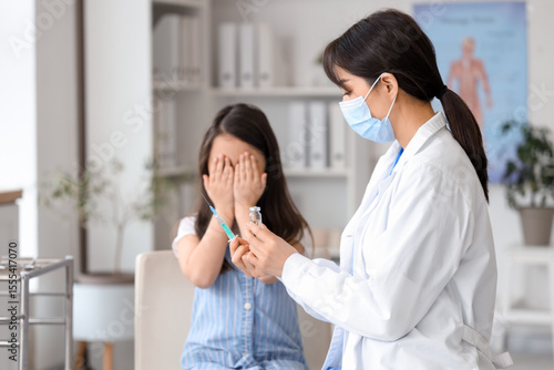 Female doctor with syringe ...