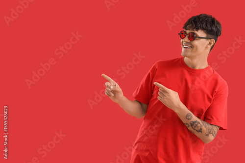 Young man in sunglasses poi...