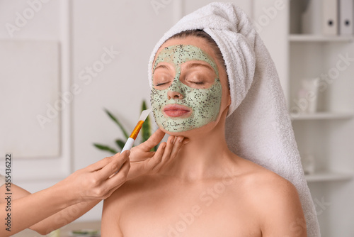 Cosmetologist applying chia...