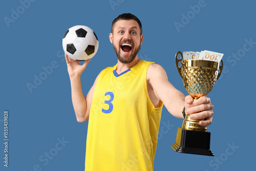 Happy male footballer with ...
