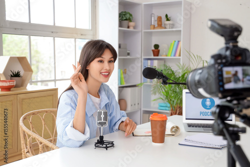 Young woman recording podca...