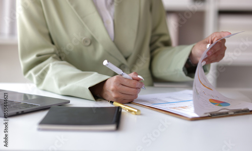 Businesswoman working on financial documents in the office. Female accountant doing accounting work and auditing.