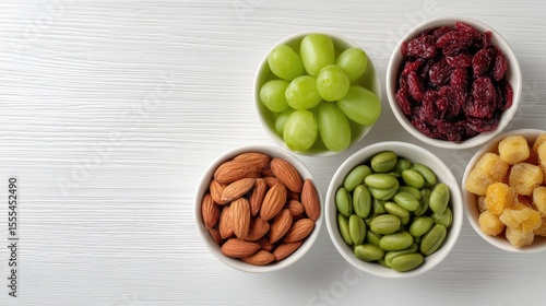 Wallpaper Mural Fresh and Healthy Snack Options Featuring Assorted Nuts and Dried Fruits in White Bowls on a Light Wooden Background for Wellness Lifestyle Concepts Torontodigital.ca