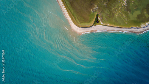 Fototapeta Naklejka Na Ścianę i Meble -  Aerial view of a pristine sandy beach meeting turquoise ocean waters with subtle wave patterns