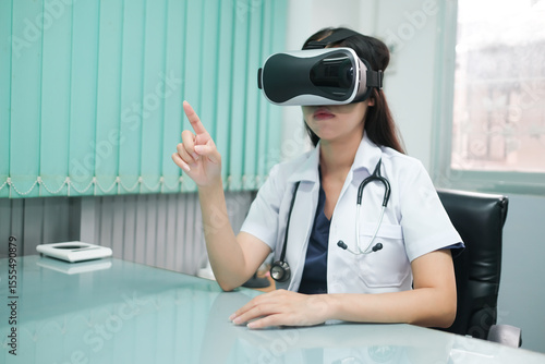 Asian female doctor in the office using VR simulation for training and treating patients with finger pointing gestures.