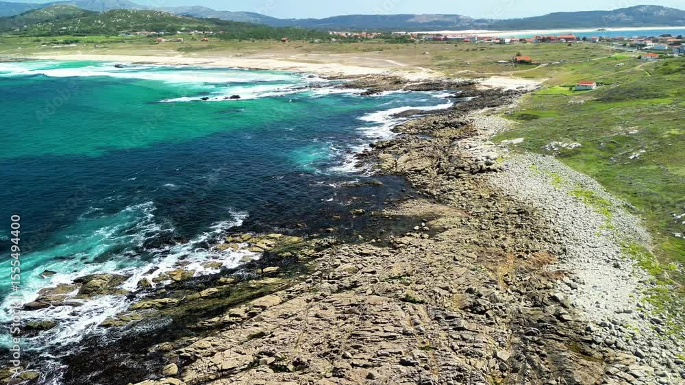 Explore stunning rocky shoreline meeting vibrant turquoise waters in this picturesque coastal scene. Explore stunning rocky shoreline meeting vibrant turquoise waters in this picturesque coastal scene.