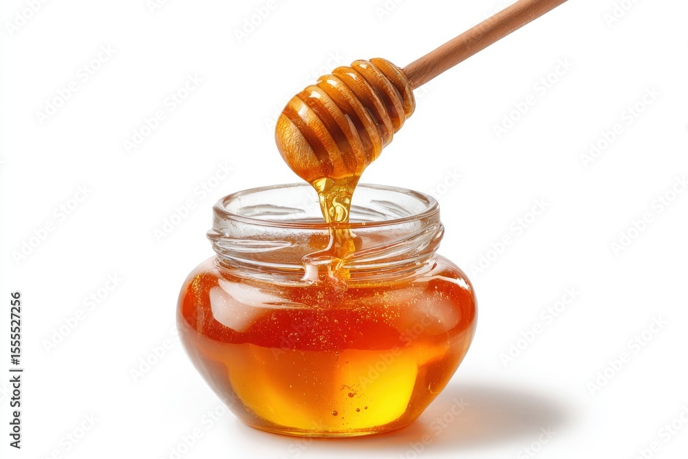 A jar fills with honey from a dipper A jar fills with honey from a dipper