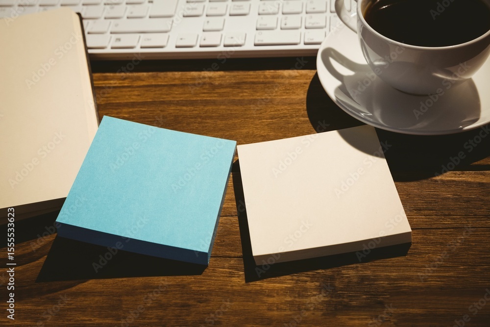 Fototapeta premium Keyboard and coffee cup on table with book
