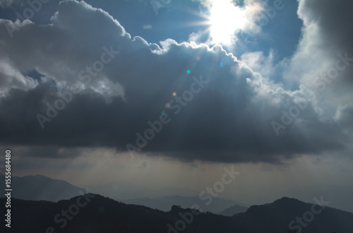 storm clouds over the mountains with light of sun