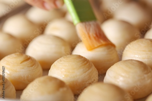 Toasted Mung Bean Cake from the oven. Chinese pastry or moon cake filled with sweet mung bean paste and salted egg yolk. Delicious pastry.