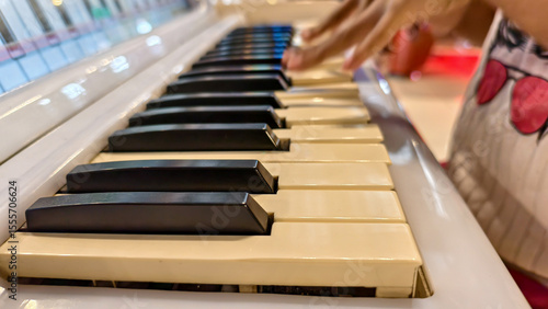 Wallpaper Mural Close-up of a person's hand playing the piano, creating melodic sounds with focused musicality Torontodigital.ca