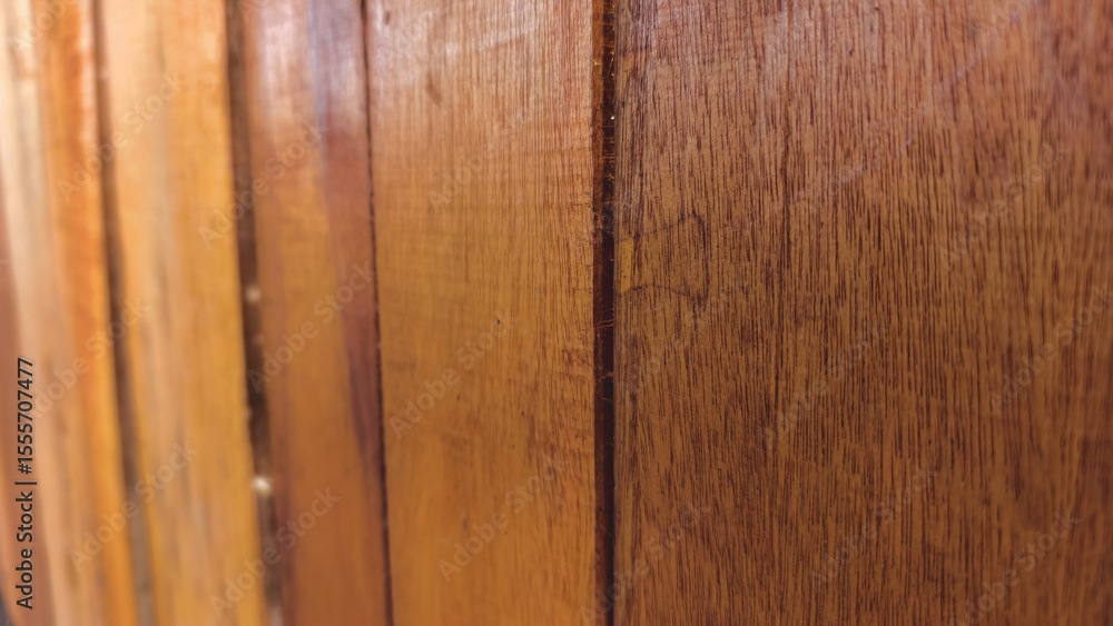 Naklejka premium Detailed close up of vertical brown wooden planks showing texture and grain in natural light