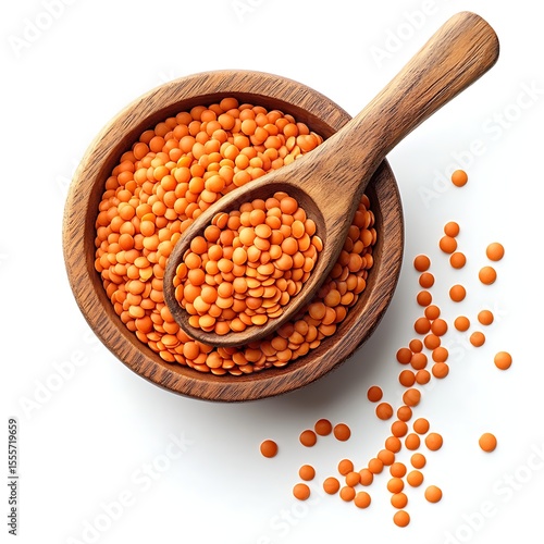 Top view of red lentils in a wooden bowl with a wooden spoon and scattered lentils on a white background