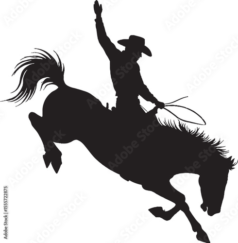 Silhouette of a cowboy riding a bucking bronco performing in a rodeo competition