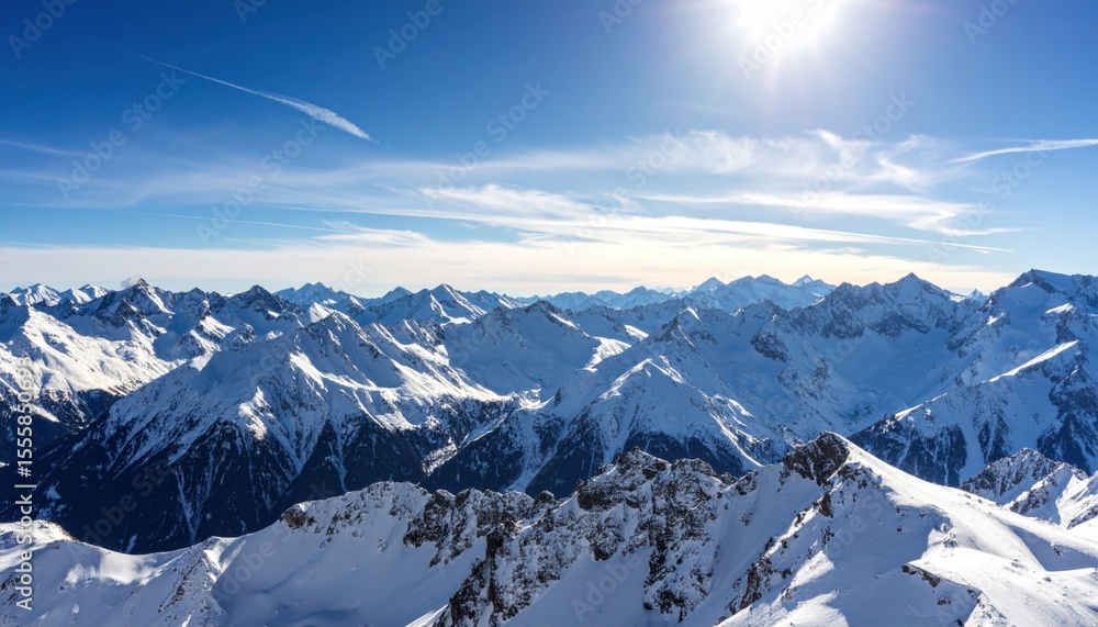 Obraz premium Breathtaking aerial view of snowy mountain peaks under a clear blue sky, showcasing nature's grandeur and serenity.