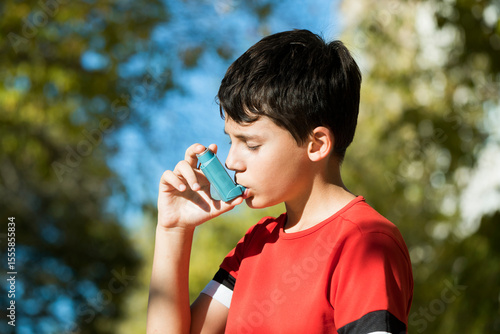 Child using  asthma inhaler to prevent allergy an asthma attack