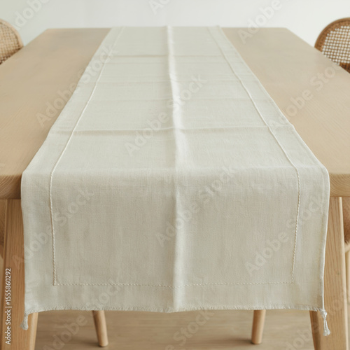 Elegant white linen table runner mockup. Blank natural tablerunner template. Long cloth table runner flat lays on wooden table
