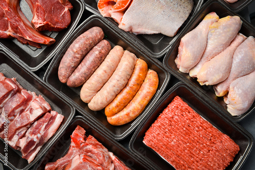 Quadro su tela Black plastic packaging trays from supermarket with different types of fresh raw