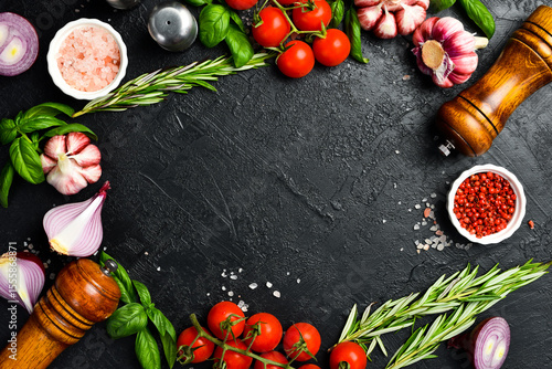 Cooking background. Top view. Spices, vegetables and seasonings on the kitchen table.