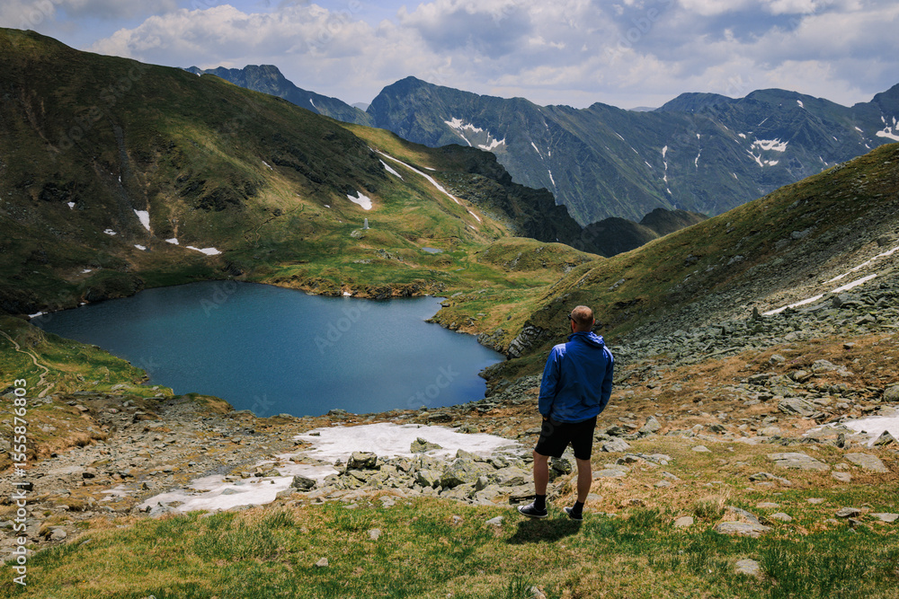 A man hiking through the mountains embraces adventure, surrounded by rugged trails, fresh air, and breathtaking views. A man hiking through the mountains embraces adventure, surrounded by rugged trails, fresh air, and breathtaking views.